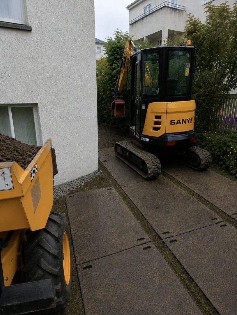 Grafa að vinna í þröngum aðstæðum við húsgrunn